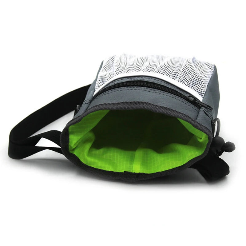 A black hands-free dog training treat pouch with a white mesh top and green lining is shown.
