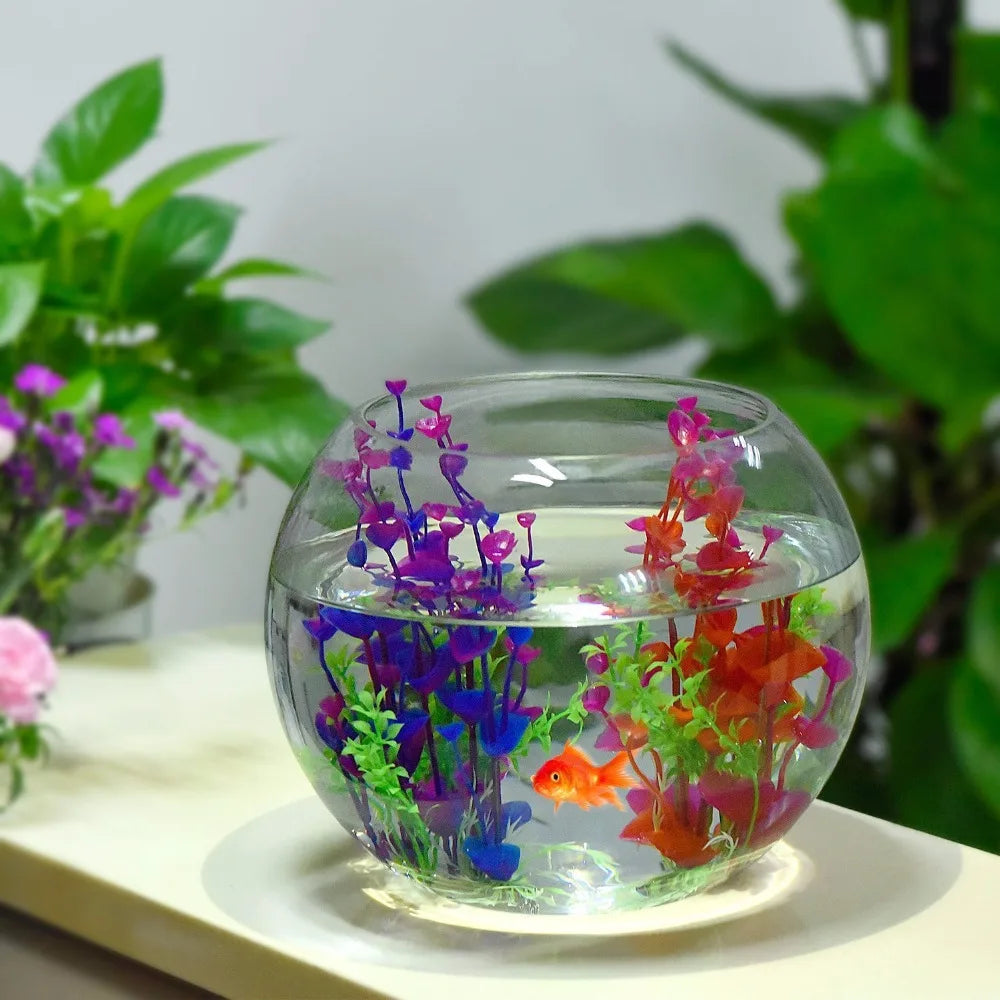 A glass aquarium filled with water and colorful artificial flowers, including purple, blue, and red blooms.