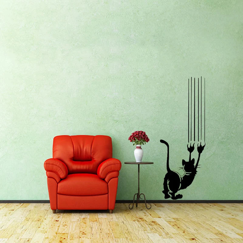 An orange armchair sits in front of a light green wall featuring a black silhouette of a cat with whiskers.