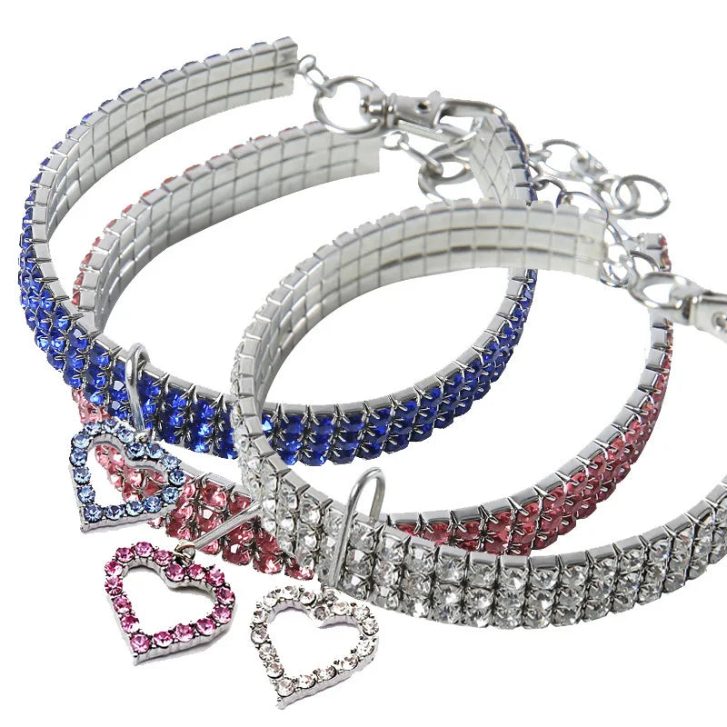 A collection of elegant rhinestone pendant cat collars in silver, blue, and pink tones.