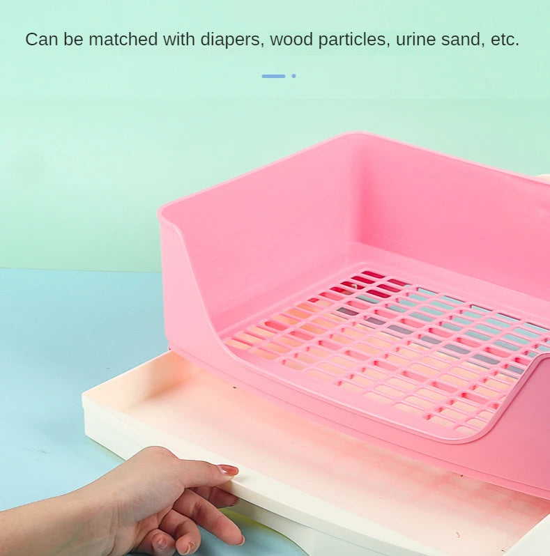 A pink anti-overturn drawer litter box is shown with a hand resting on the white tray.