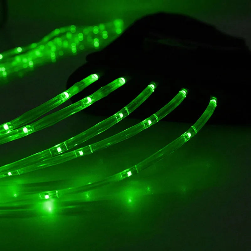 A close-up of a green LED horse tail light with multiple flexible filaments illuminating the surface.