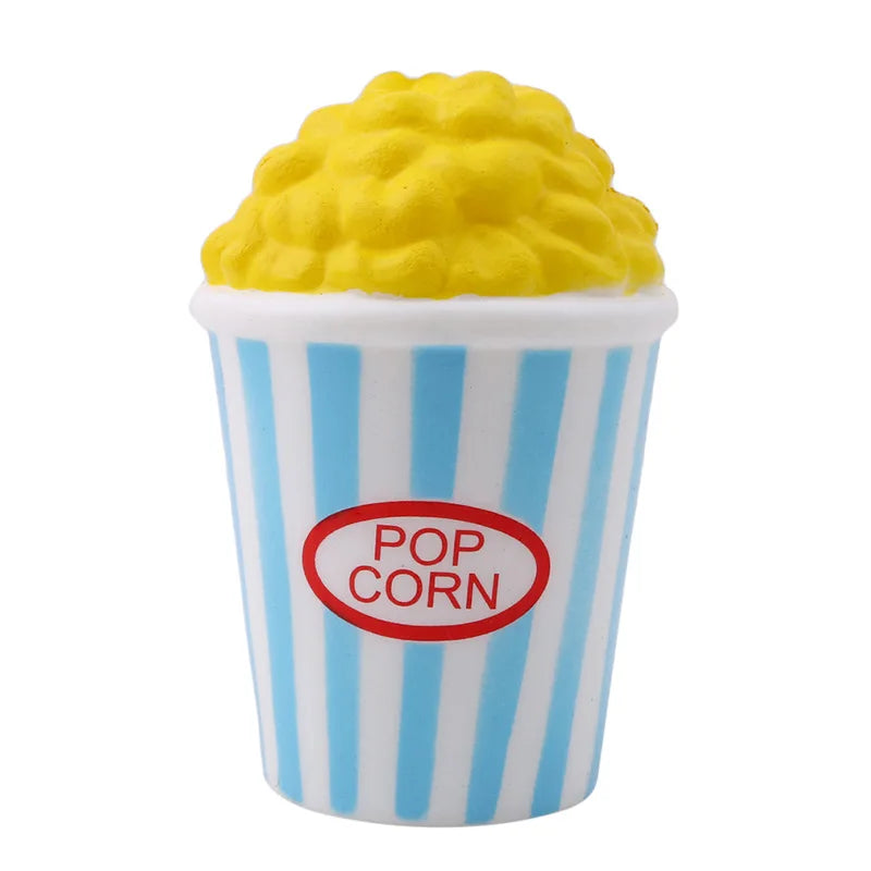 A yellow corn-shaped squishy toy is visible inside a striped paper cup.