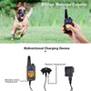 A dog is running in a grassy field next to a hand holding an 800yd remote control device for training.