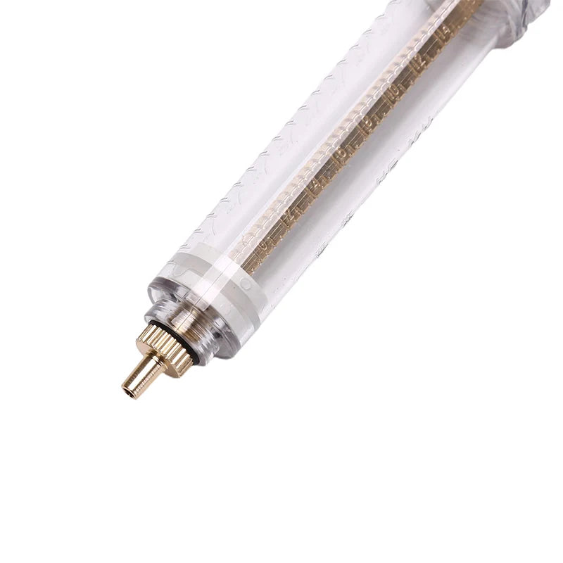 A clear plastic feeding syringe with a soft hose and gold accents for parrot feeding.