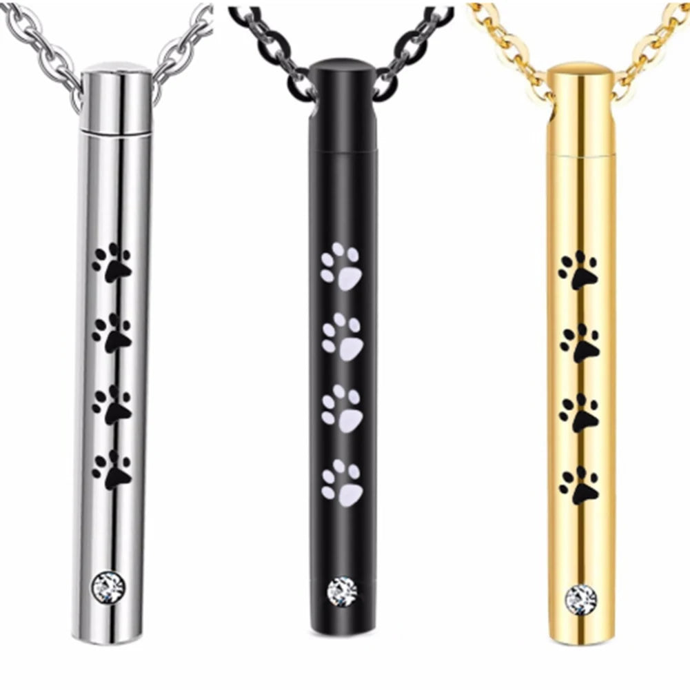 Three stainless steel pet memorial necklaces in silver, black, and gold finishes.
