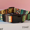 A personalized printed dog collar and leash set featuring colorful patterned fabric on a black leather strap.