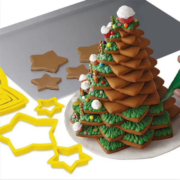 A set of six star-shaped cookie cutters used for cake decorating, displayed next to a Christmas tree shaped cookie.