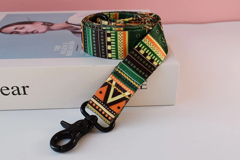 A patterned fabric dog collar and leash set displayed next to a book.