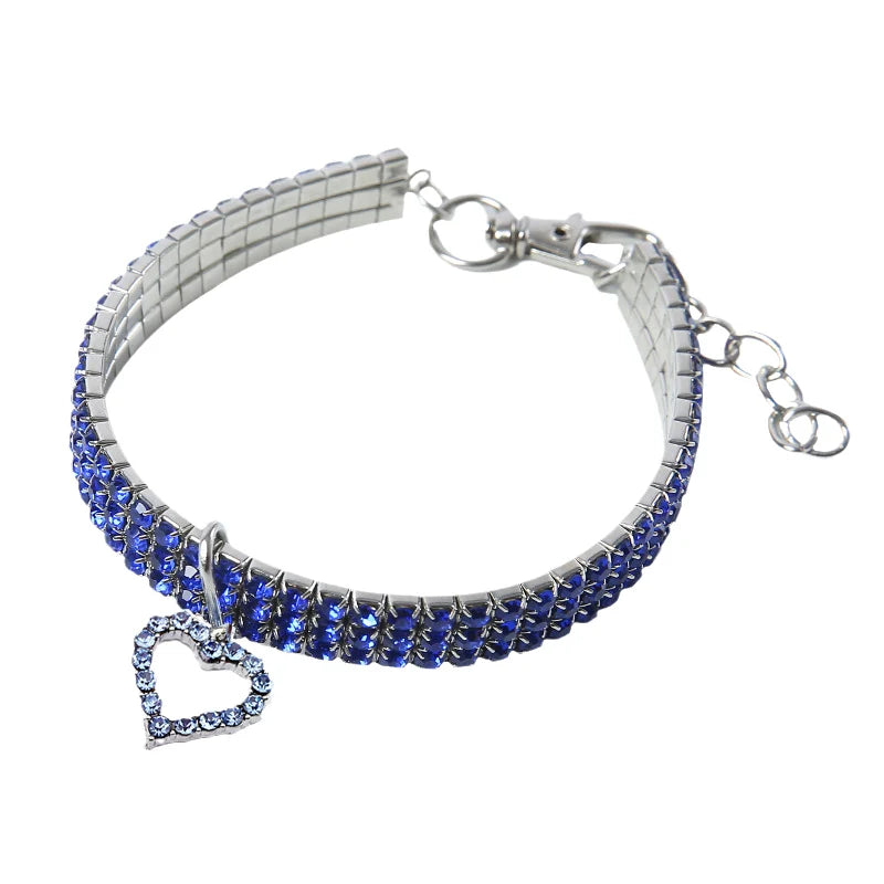 Silver collar bracelet with blue rhinestones and a heart pendant