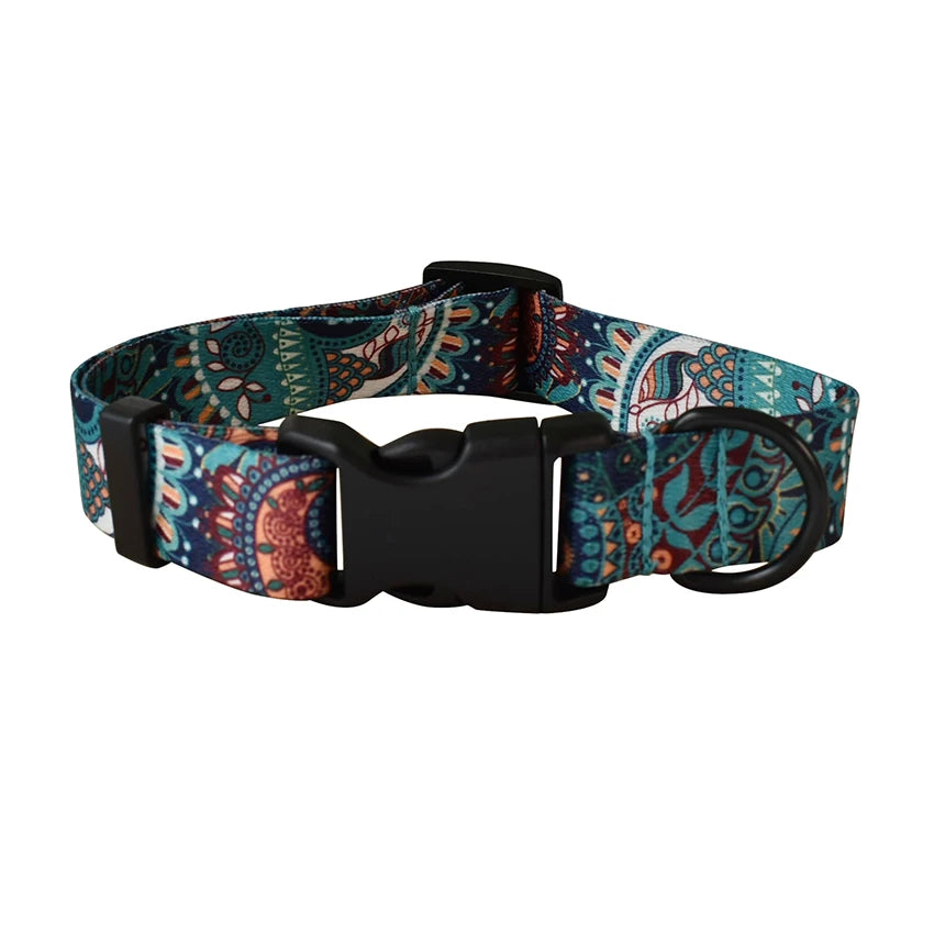 A patterned fabric dog collar and leash set featuring intricate paisley designs in teal, blue, and brown.