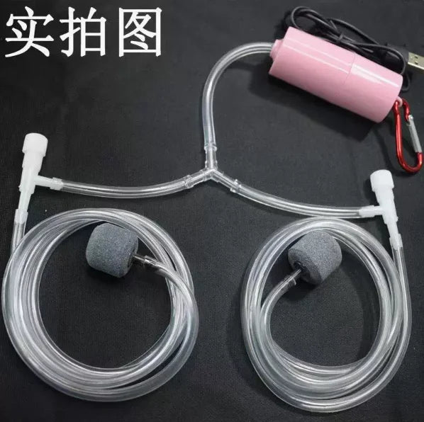 A clear tubing system with a pink pump and two aerator nozzles for an aquarium oxygen setup.