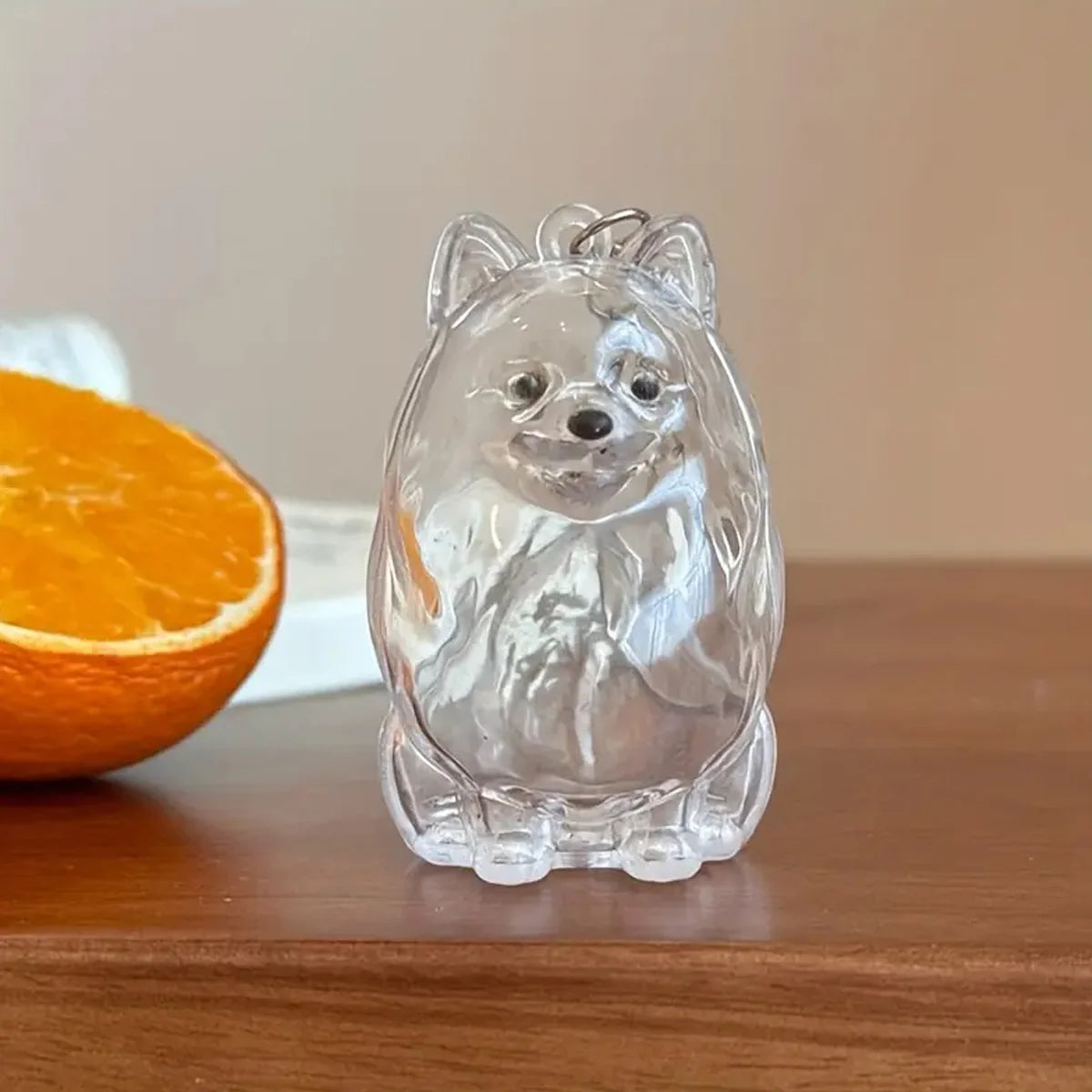 Clear silicone keychain shaped like a dog with pet hair storage features