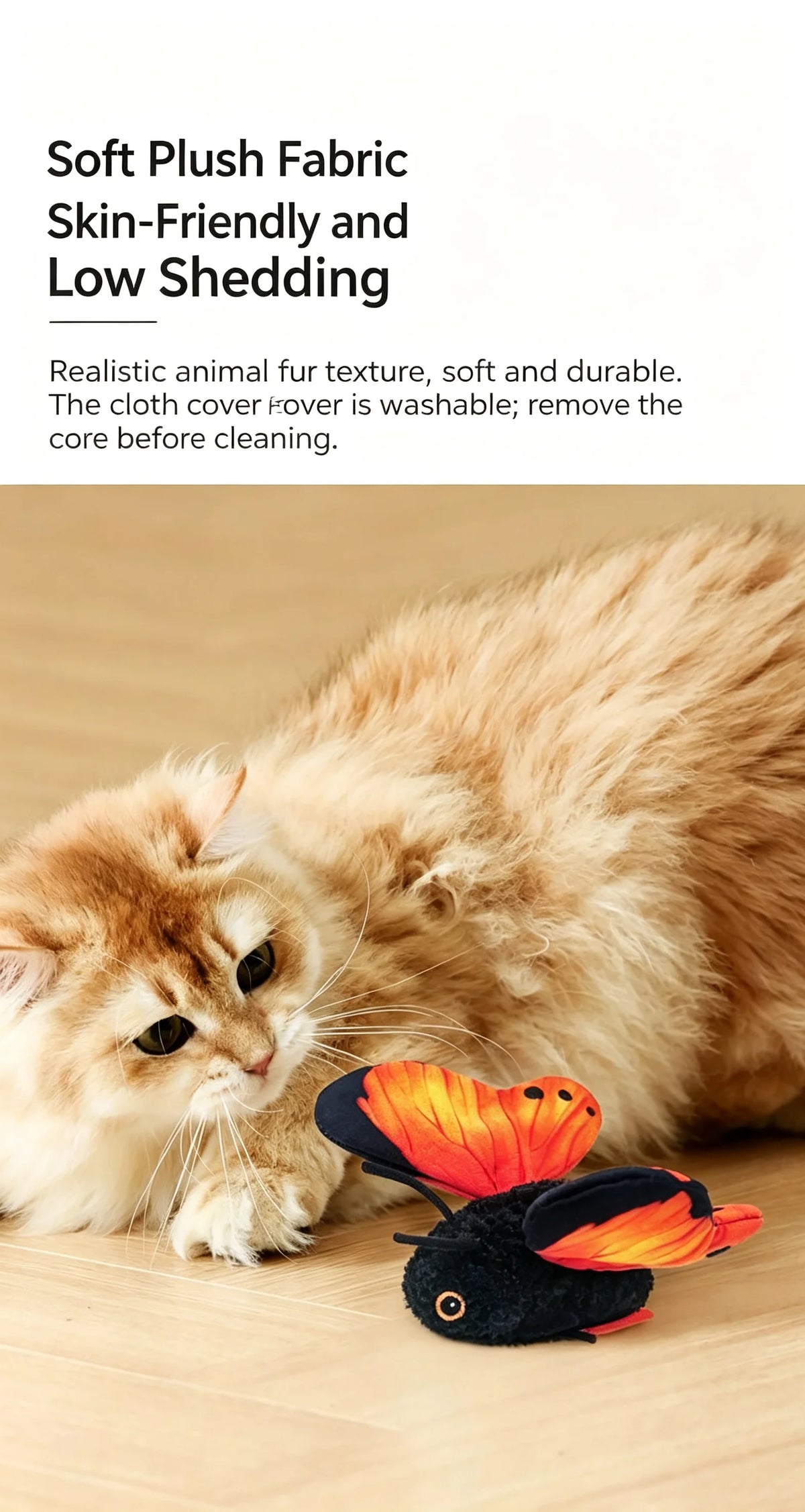 A fluffy orange tabby cat lies next to a small, dark butterfly toy.