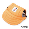 An orange pet grooming visor cap for dogs and cats with a small tag on the front.
