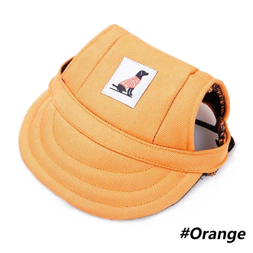 An orange pet grooming visor cap for dogs and cats with a small tag on the front.