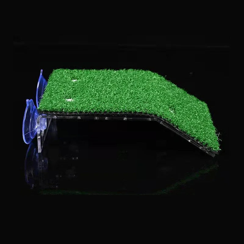 A green grass ramp platform with suction cups is shown against a black background.