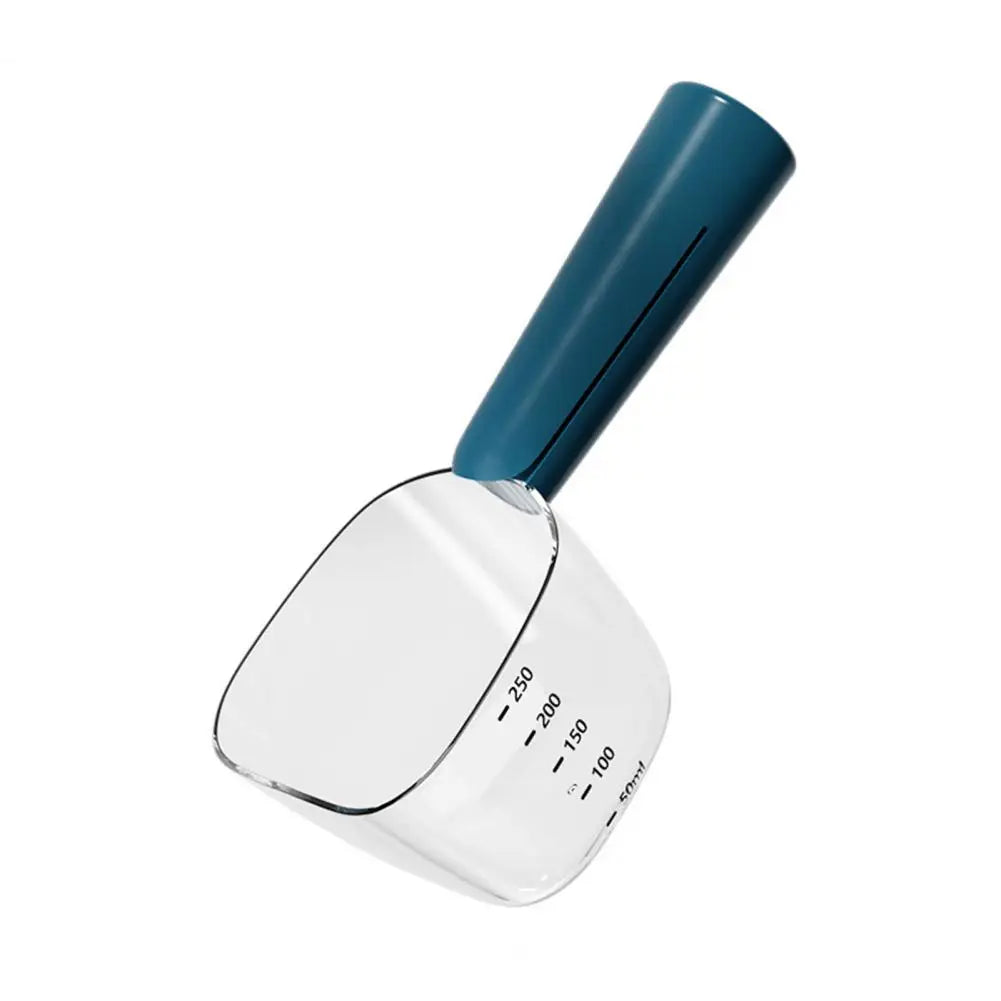 A clear measuring scoop for pet food with a teal handle and a separate wet food spoon.