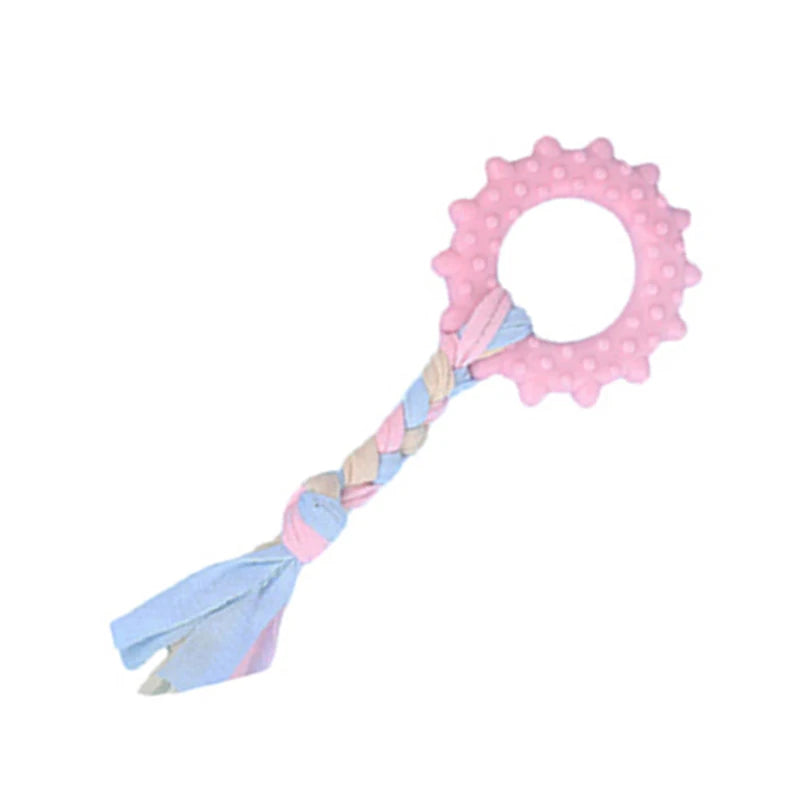 Pink rubber chew toy for small dogs featuring a dental cleaning texture and a pink circular shape.