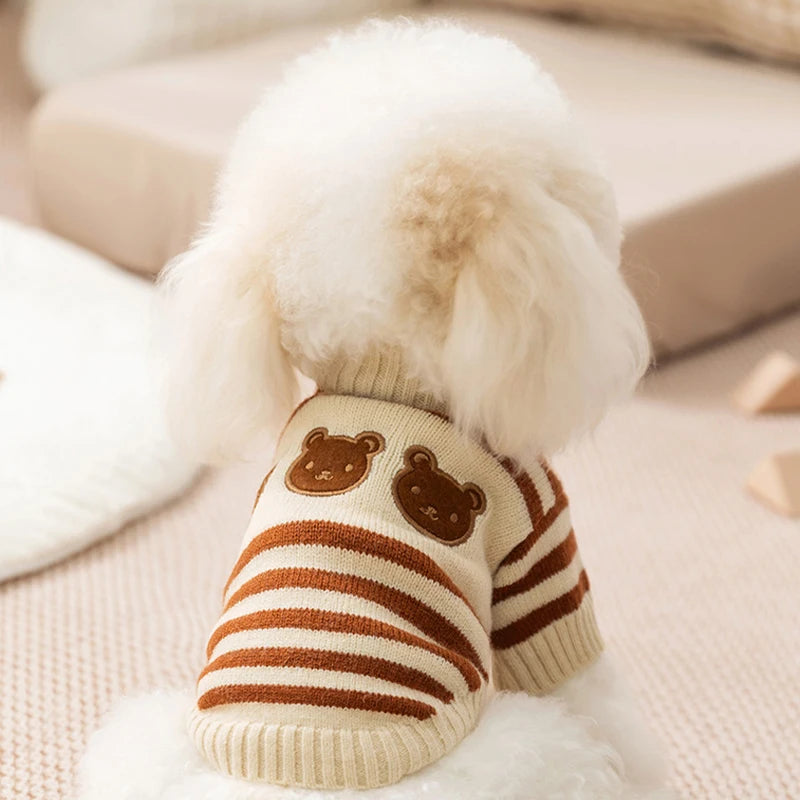A beige striped bear cardigan pet sweater for small dogs and cats with a fluffy white pom-pom.