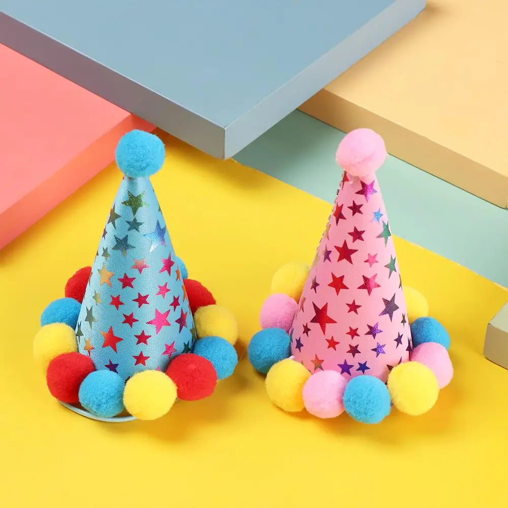 A collection of colorful sequin pet party headwear and bibs for dogs and cats displayed on a yellow surface.