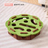 A green felt puzzle toy shaped like a leaf with holes for a cat, made of brown felt.