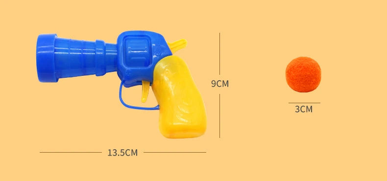 Blue and yellow interactive cat toy gun with a soft orange plush ball shown against a beige background.
