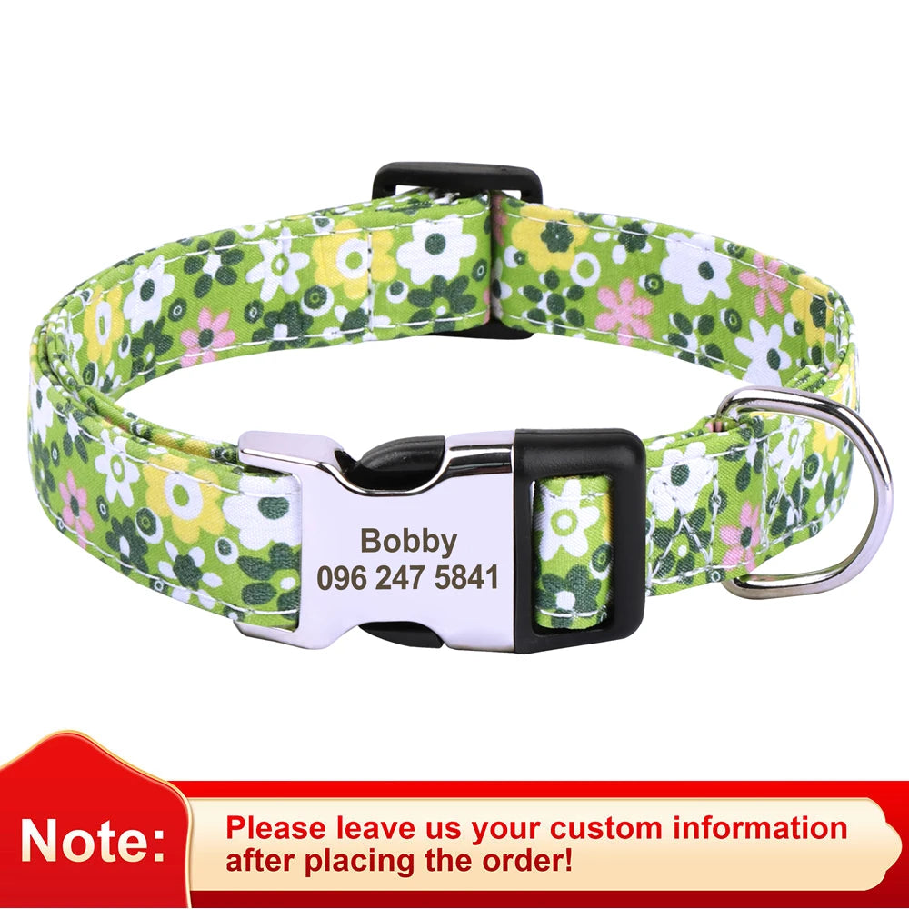 A floral print dog collar with a black buckle and a white name tag engraved with a phone number.