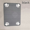 A black pet feeding mat with a gray chevron pattern and white paw prints.