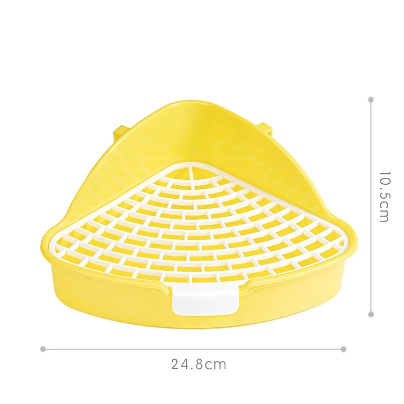 Yellow corner litter box for small pets with a white grate and a rectangular drain plug.
