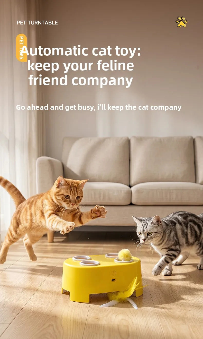 A small orange tabby cat plays with a yellow interactive toy designed to keep it company.