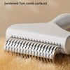 A white pet grooming brush with widened teeth is shown resting on golden fur.