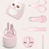 A pink portable nail care set featuring a pair of small scissors, a cuticle pusher, and a nail file.