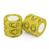 Rolle gelber selbstklebender Tattoo-Griffverband mit schwarzen Smiley-Designs.