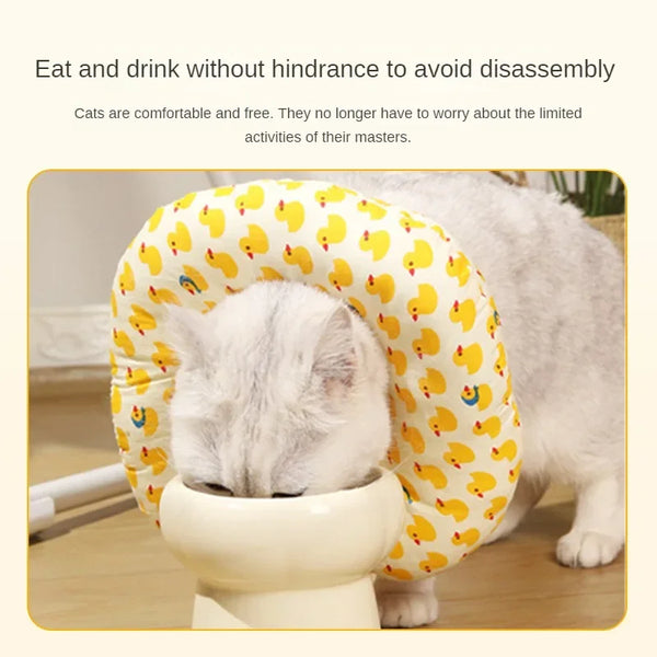 A white cat is resting comfortably inside a yellow patterned soft cotton recovery collar for dogs and cats.