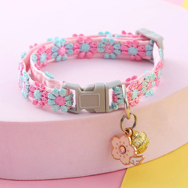 Pink and blue crocheted pet collar with a gold bell attached