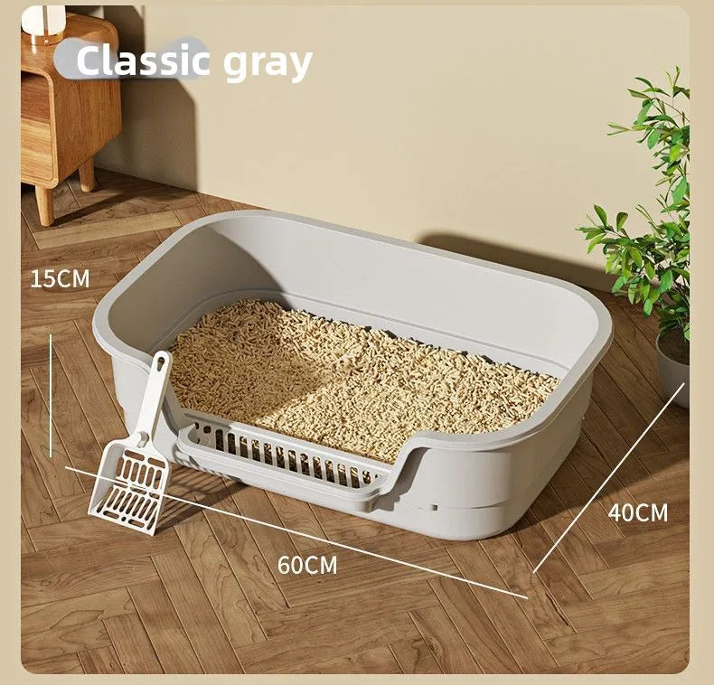 A large, semi-enclosed cat litter box in classic gray is shown on a wooden floor.