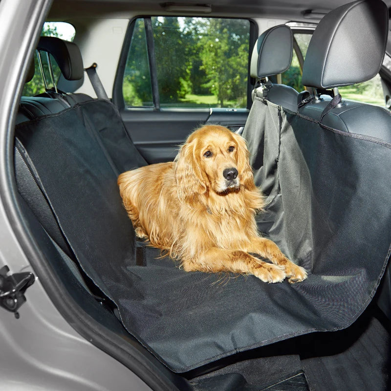 A golden retriever lies comfortably in a black waterproof dog car seat hammock inside a vehicle.