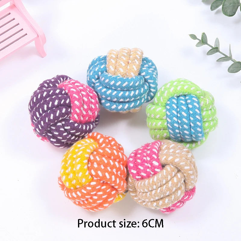 A collection of six colorful hemp rope chew toys for dogs in various shades of purple, blue, green, and orange.