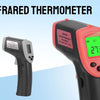 A digital infrared thermometer in orange and black is shown next to a green display reading 27.3 degrees.