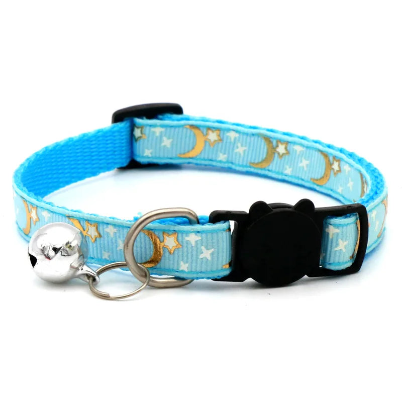 Light blue pet collar with a black buckle and silver bell necklace featuring gold crescent moon stars