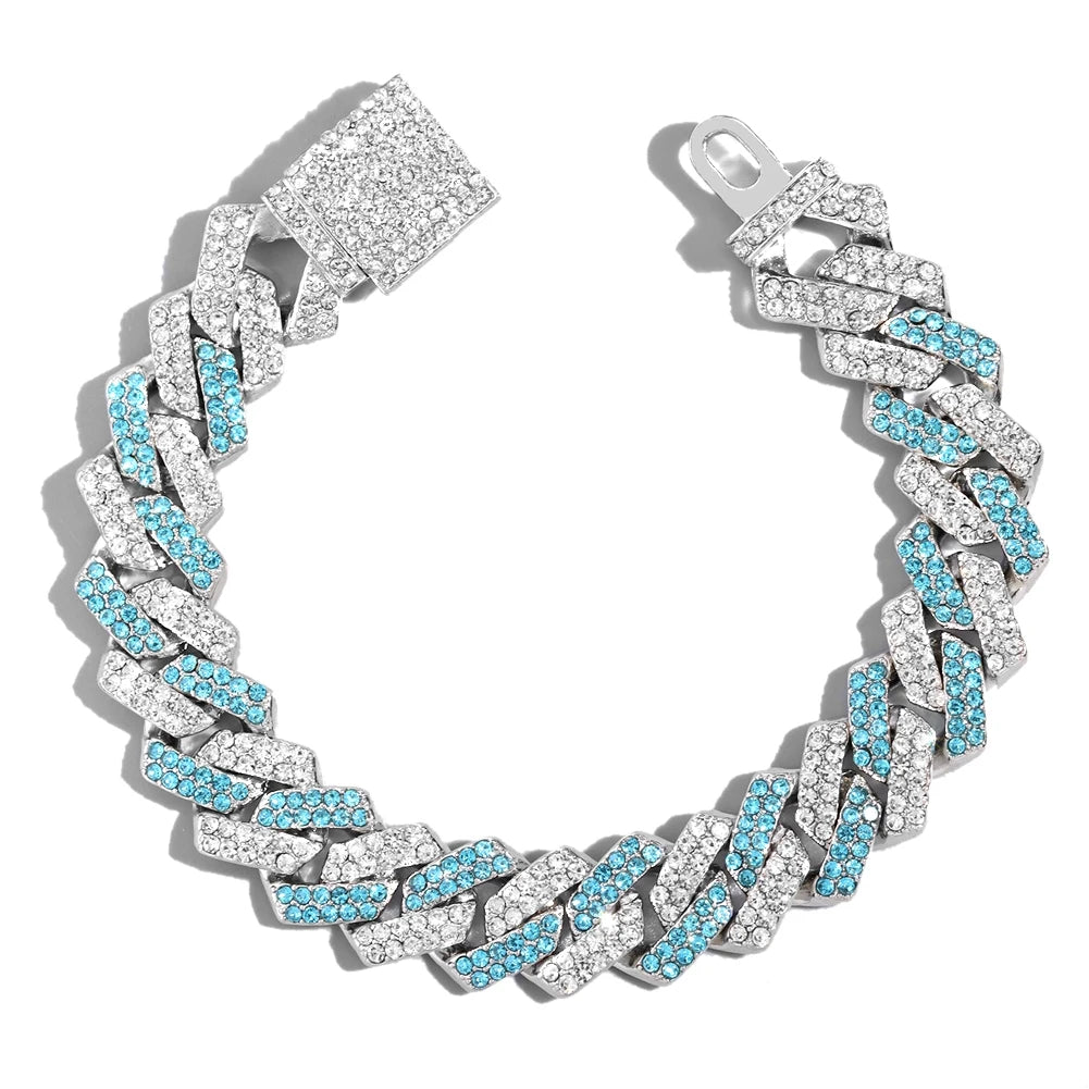 A silver iced-out Cuban link bracelet featuring blue and clear rhinestones.