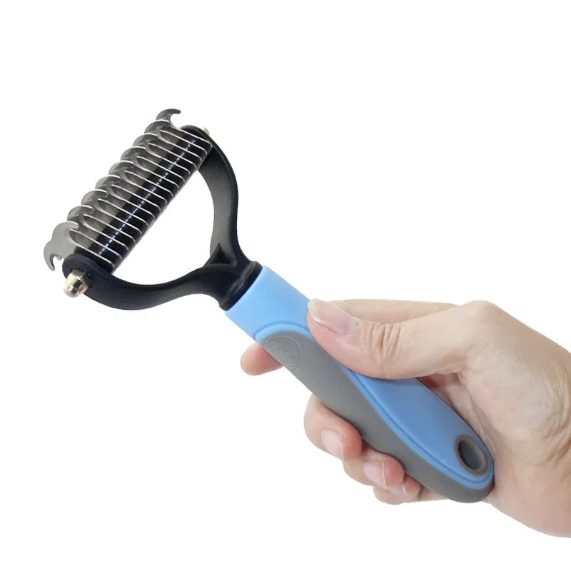 A hand holds a black and blue pet hair removal comb brush with a metal comb for dogs and cats.