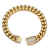 A gold-toned stainless steel curb chain bracelet with a textured, diamond-encrusted clasp.