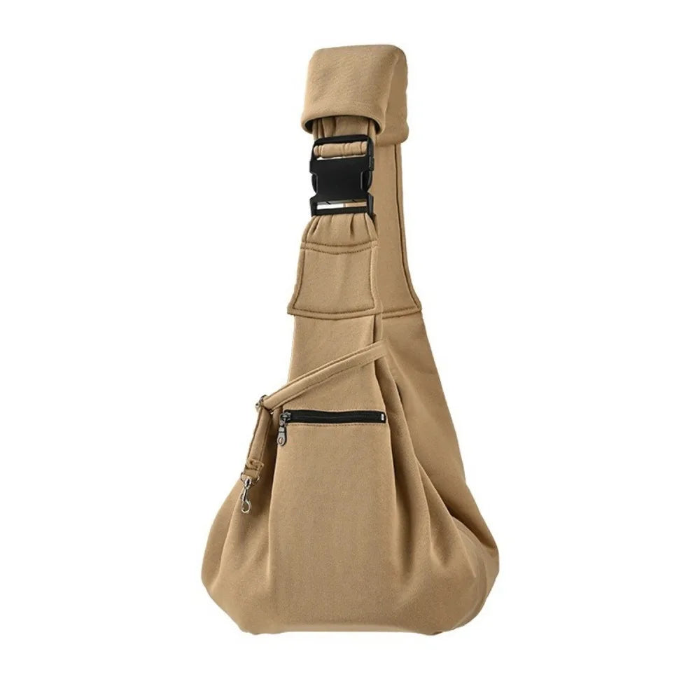 Tan double-sided pet carrier bag with a black safety harness visible from the front.