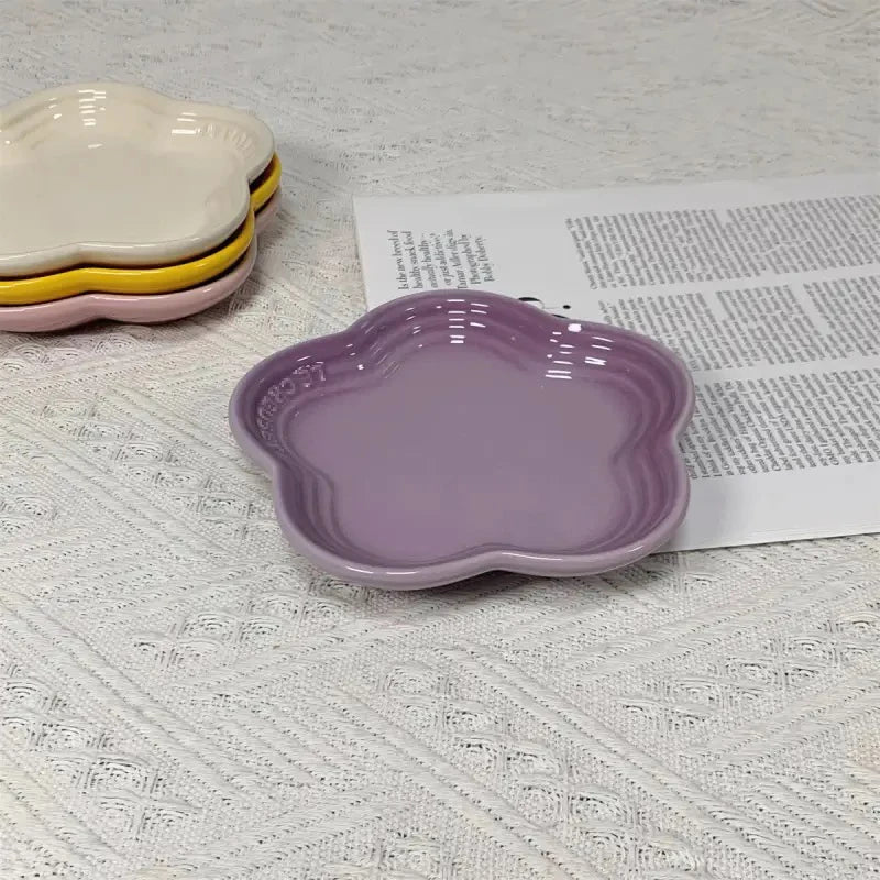 A set of decorative ceramic flower-shaped pet bowl and dipping dish in rainbow plum blossom colors.
