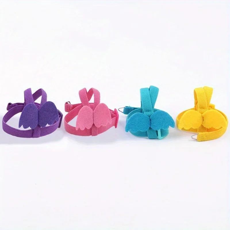 Four colorful parrot flying harnesses in purple, pink, teal, and yellow.