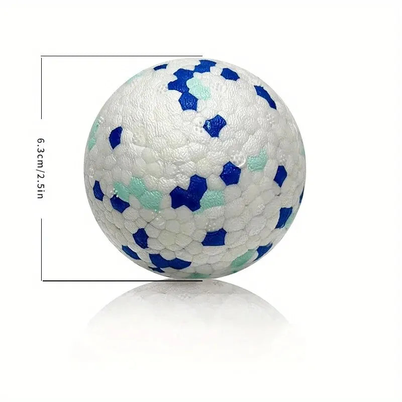 A white TPU dog chew ball patterned with blue and light green irregular shapes.