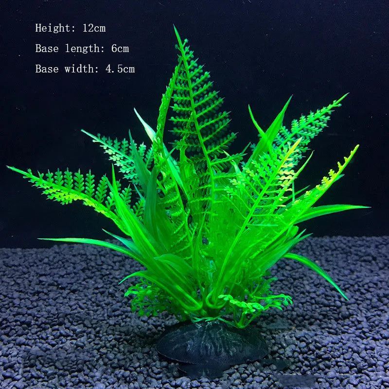 A vibrant green artificial aquarium plant with a feathery frond displayed in a small pot on dark gravel.