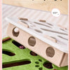 A felt puzzle toy for cats showing a wooden base with slots and a piece of felt designed to be gripped.